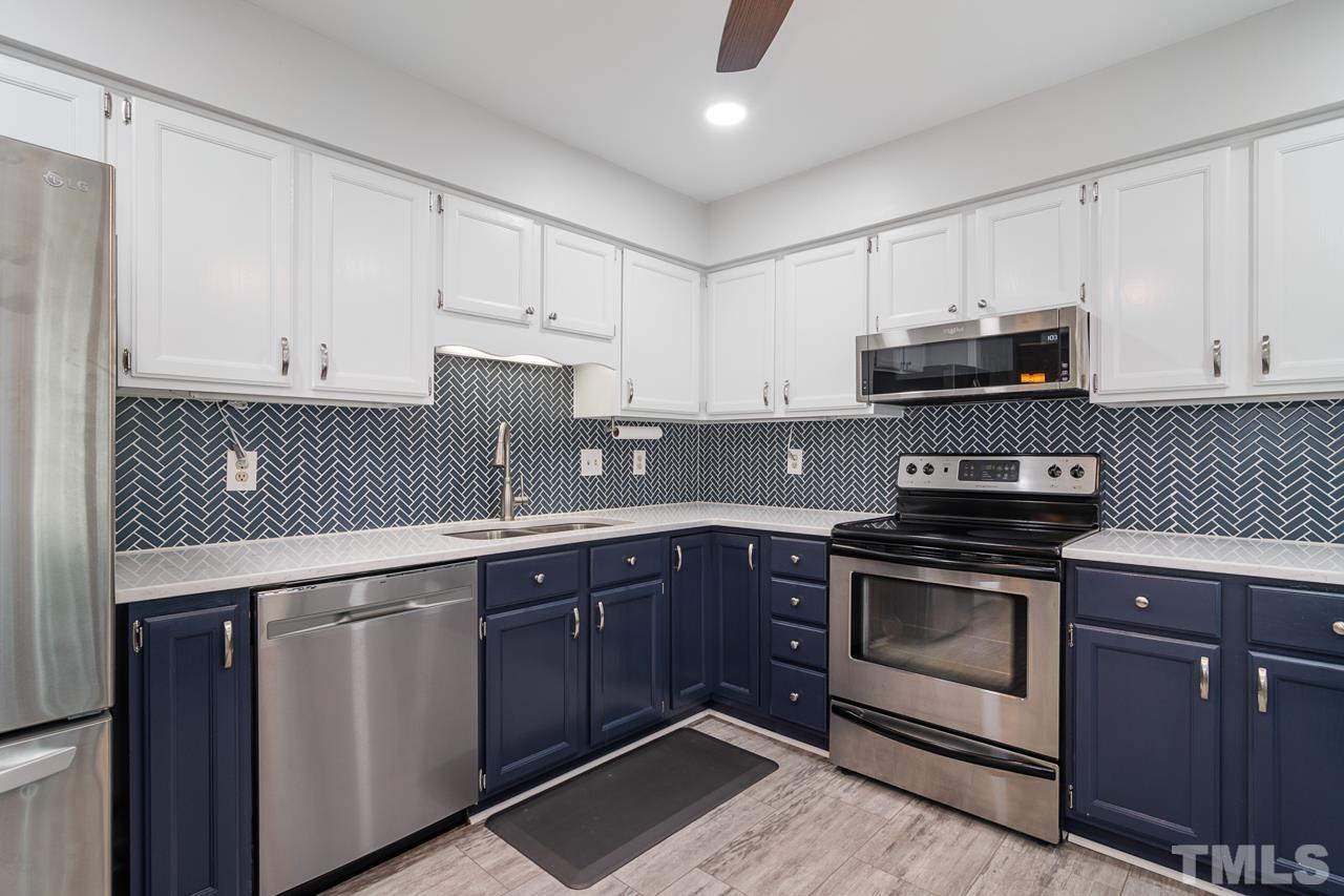 1426 Mapleside Court Raleigh, NC 27609 - Photo 12 of 38 a kitchen with granite countertop cabinets stainless steel appliances and a sink