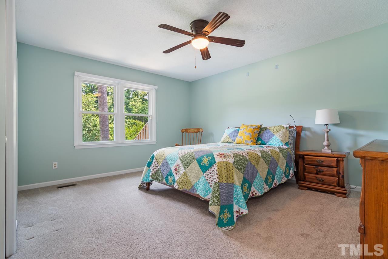 1426 Mapleside Court Raleigh, NC 27609 - Photo 14 of 38 a bedroom with a bed and window