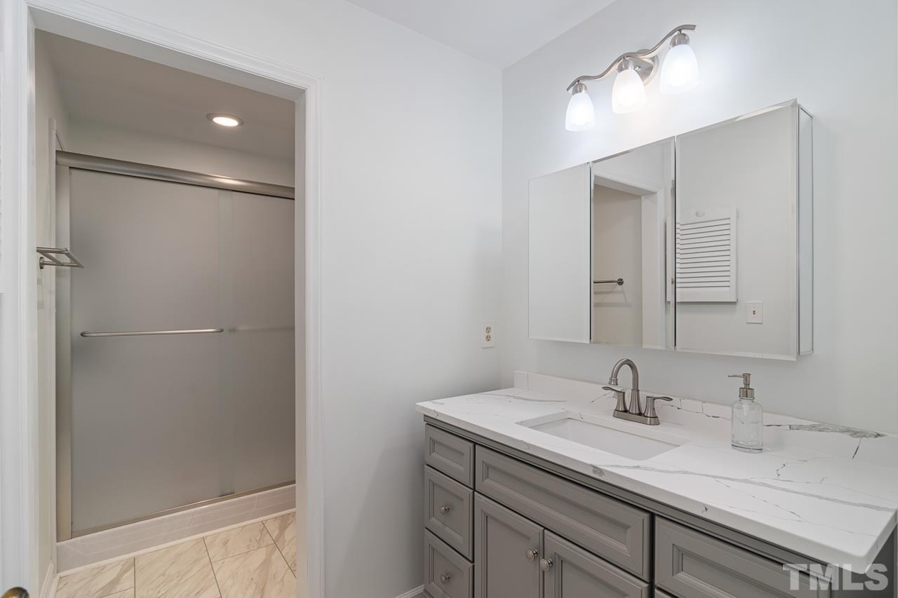 1426 Mapleside Court Raleigh, NC 27609 - Photo 17 of 38 a bathroom with a sink double vanity and a mirror
