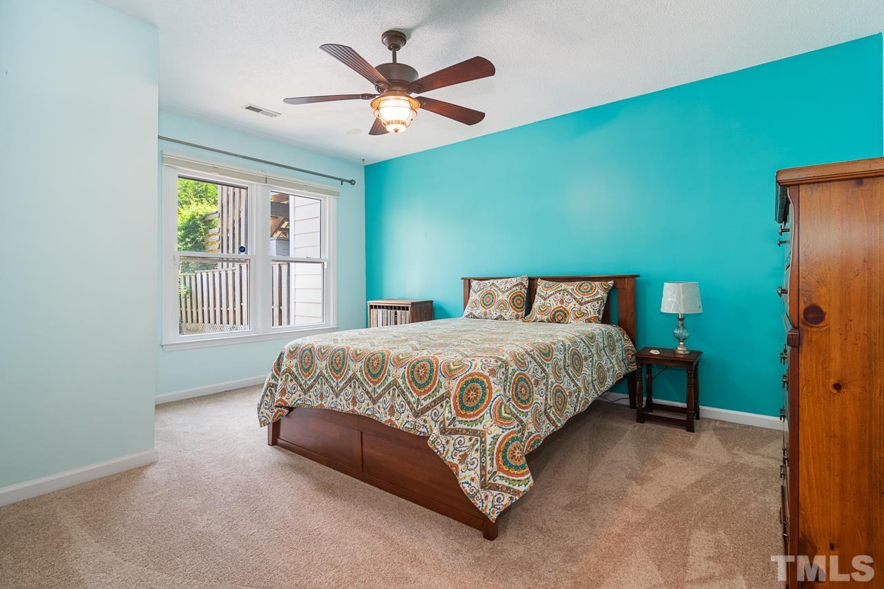 1426 Mapleside Court Raleigh, NC 27609 - Photo 18 of 38 a bedroom with a large bed and a large window