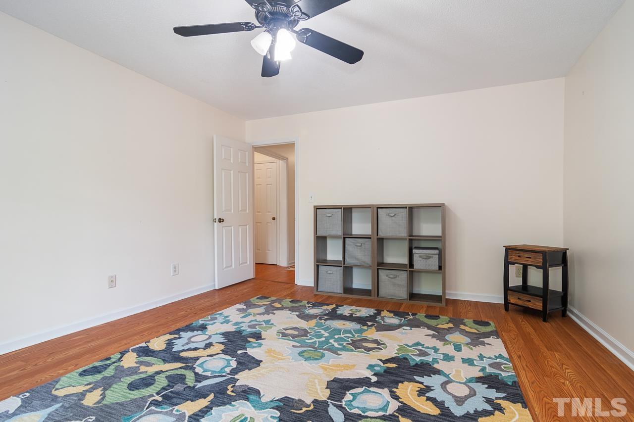 1426 Mapleside Court Raleigh, NC 27609 - Photo 24 of 38 a bedroom with a bed and a dresser