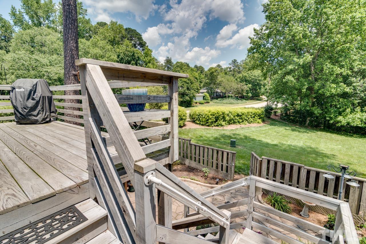 1426 Mapleside Court Raleigh, NC 27609 - Photo 36 of 38 a view of a deck with two chair and a floor to ceiling window