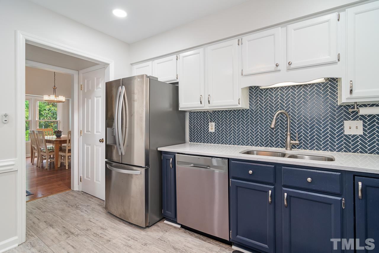 1426 Mapleside Court Raleigh, NC 27609 - Photo 9 of 38 a kitchen with a refrigerator sink and cabinets