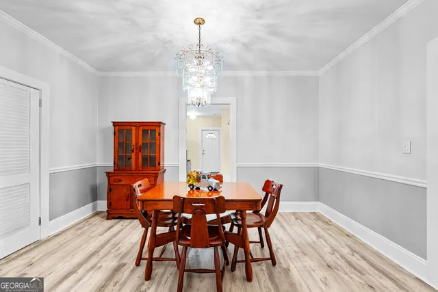a view of a dining room with furniture and wooden floor