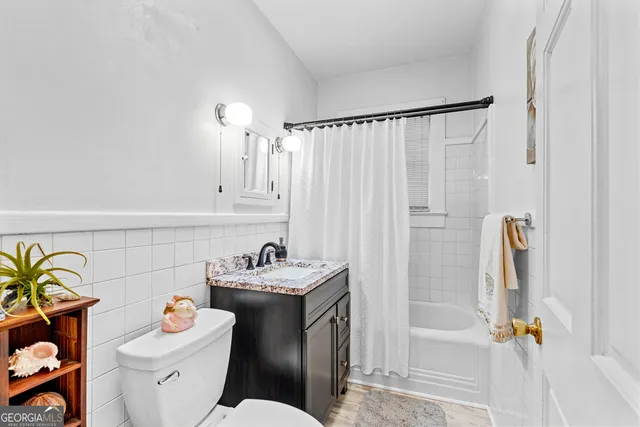 a bathroom with a sink vanity tub and shower