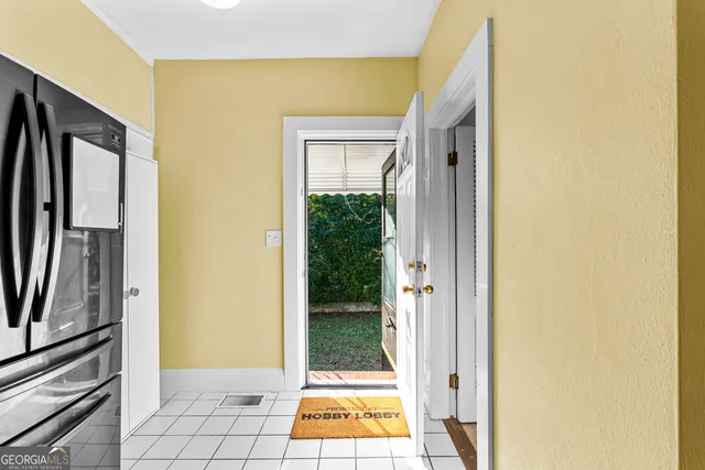 a white house that has a tree in front of it