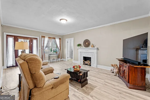 a view of a livingroom with a fireplace and wooden floor