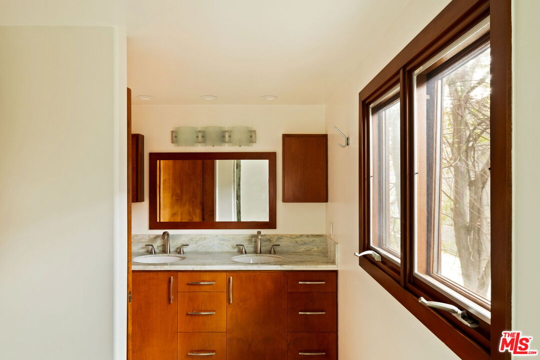 2325 Abbot Kinney Boulevard Venice, CA 90291 - Photo 16 of 32 a bathroom with a granite countertop sink and a mirror