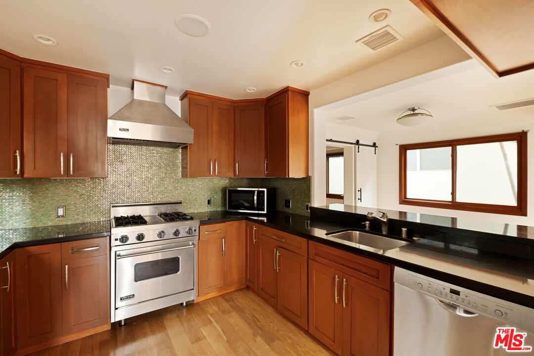 2325 Abbot Kinney Boulevard Venice, CA 90291 - Photo 7 of 32 a kitchen with a sink stove and cabinets