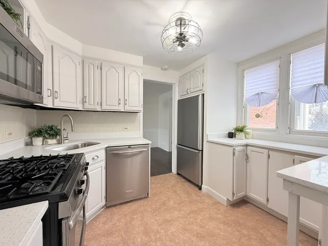 a view of cabinets a sink and a window