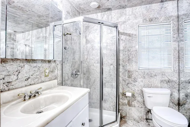 a bathroom with a sink toilet and shower