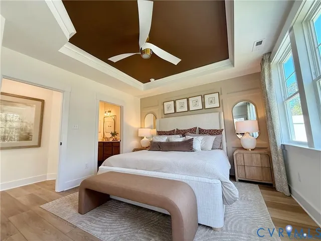 a bedroom with a bed chandelier and a window