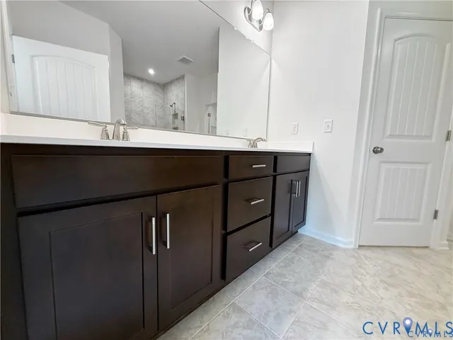 a bathroom with a sink vanity and a mirror