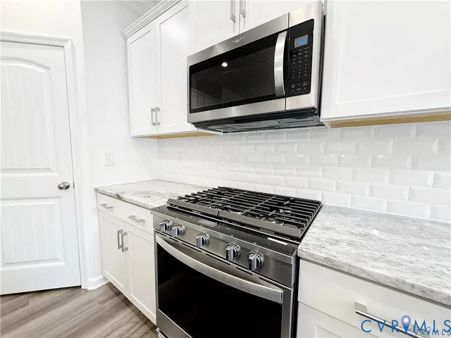 a stove top oven sitting inside of a kitchen