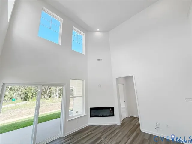 a view of hallway with wooden floor and window