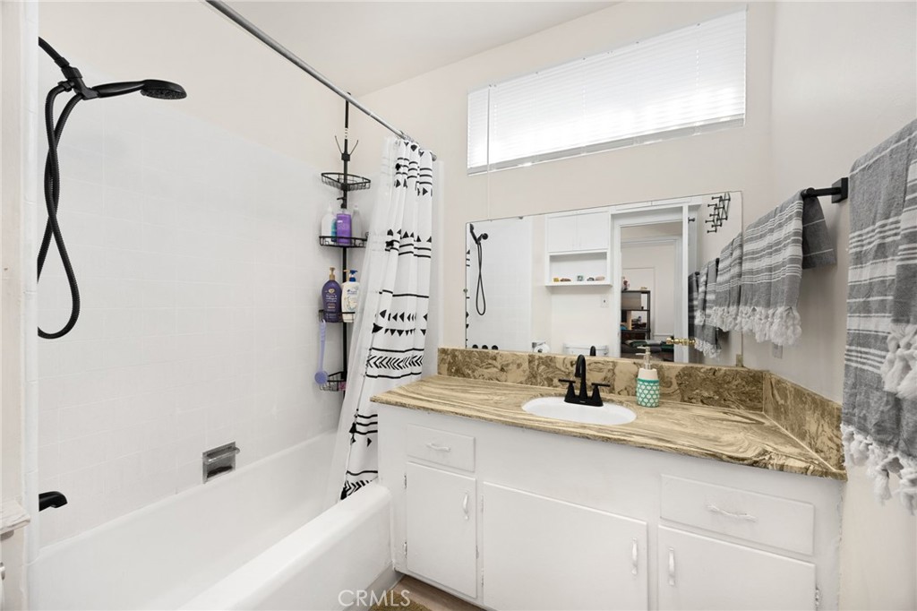 4577 Ranger Avenue El Monte, CA 91731 - Photo 18 of 25 a bathroom with a granite countertop sink a mirror and shower