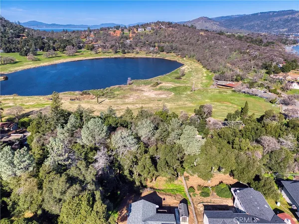 an aerial view of residential houses with outdoor space and river