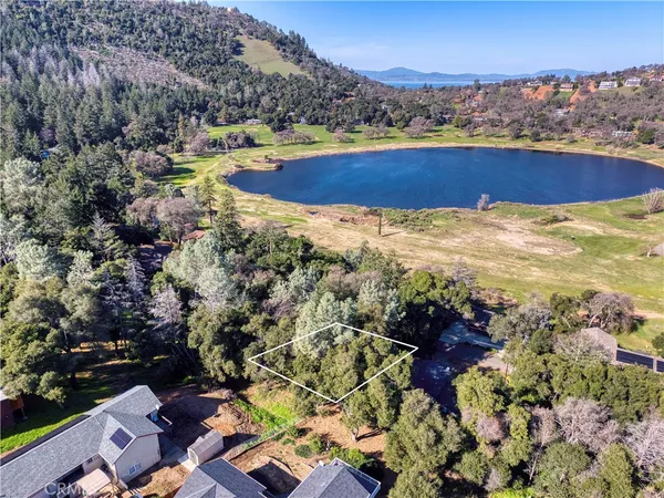an aerial view of residential houses with outdoor space and river