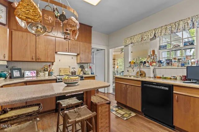a dining room with furniture a chandelier and wooden floor