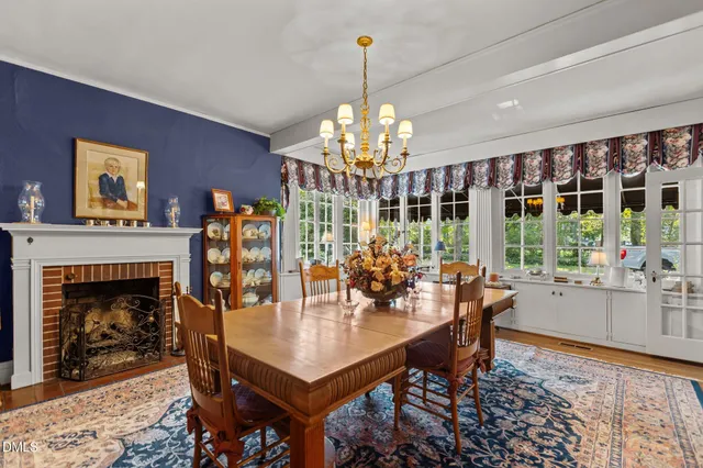 a view of a dining room with furniture and chandelier
