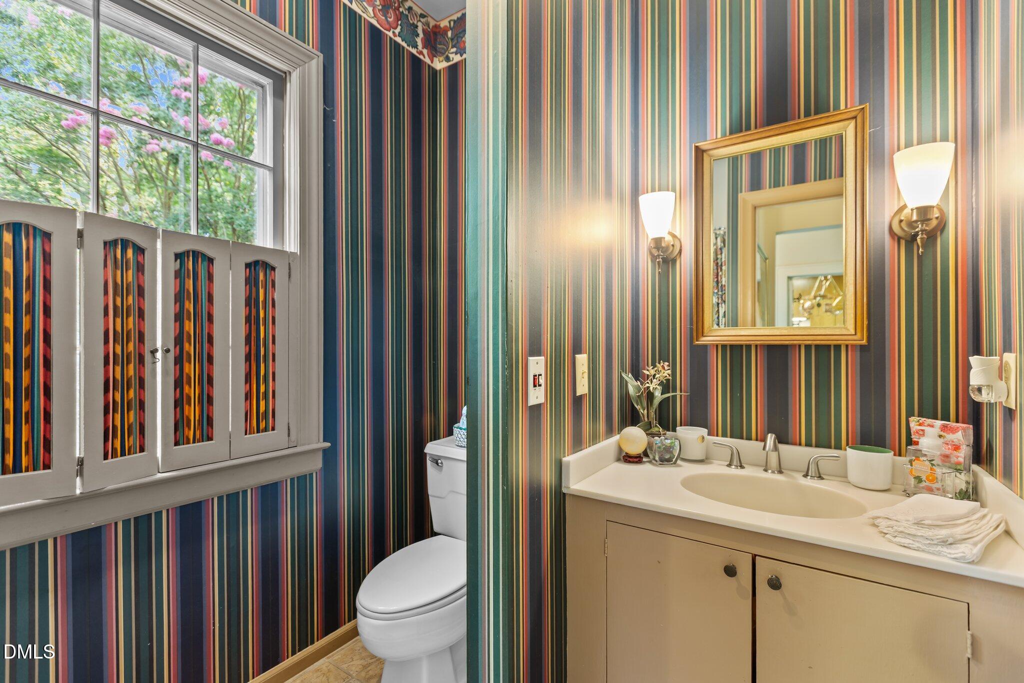 3724 Hope Valley Road Durham, NC 27707 - Photo 19 of 55 a bathroom with a sink a toilet and a mirror