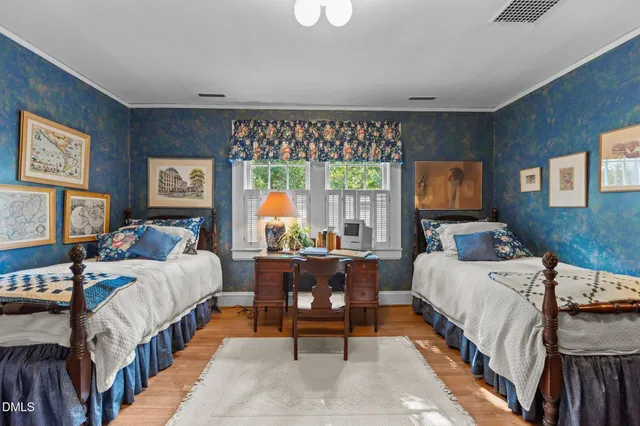 a bedroom with furniture and mirror