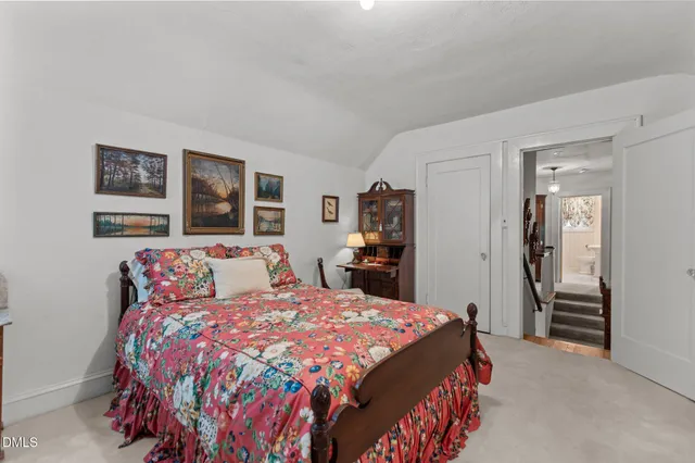 a bed room with a bed and chair