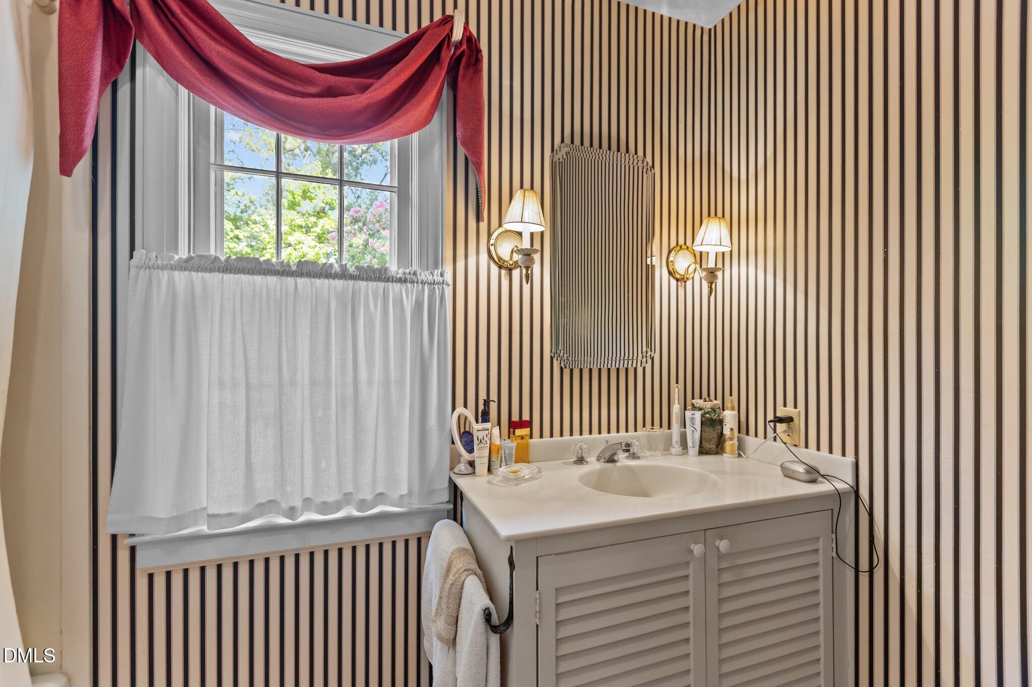 3724 Hope Valley Road Durham, NC 27707 - Photo 30 of 55 a bathroom with a sink and a mirror