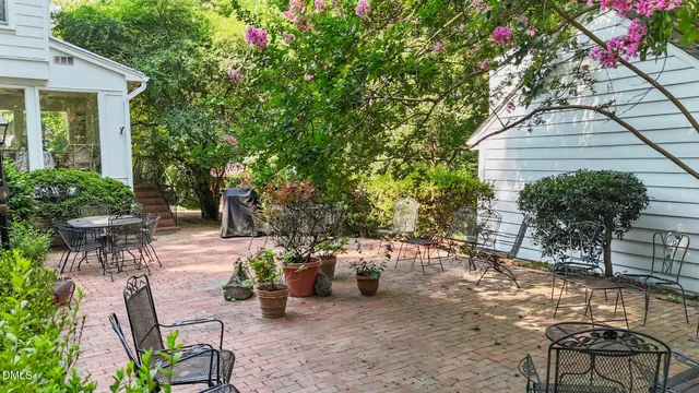 a aerial view of a house with a yard and potted plants
