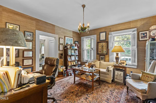 a living room with furniture fireplace and a large window