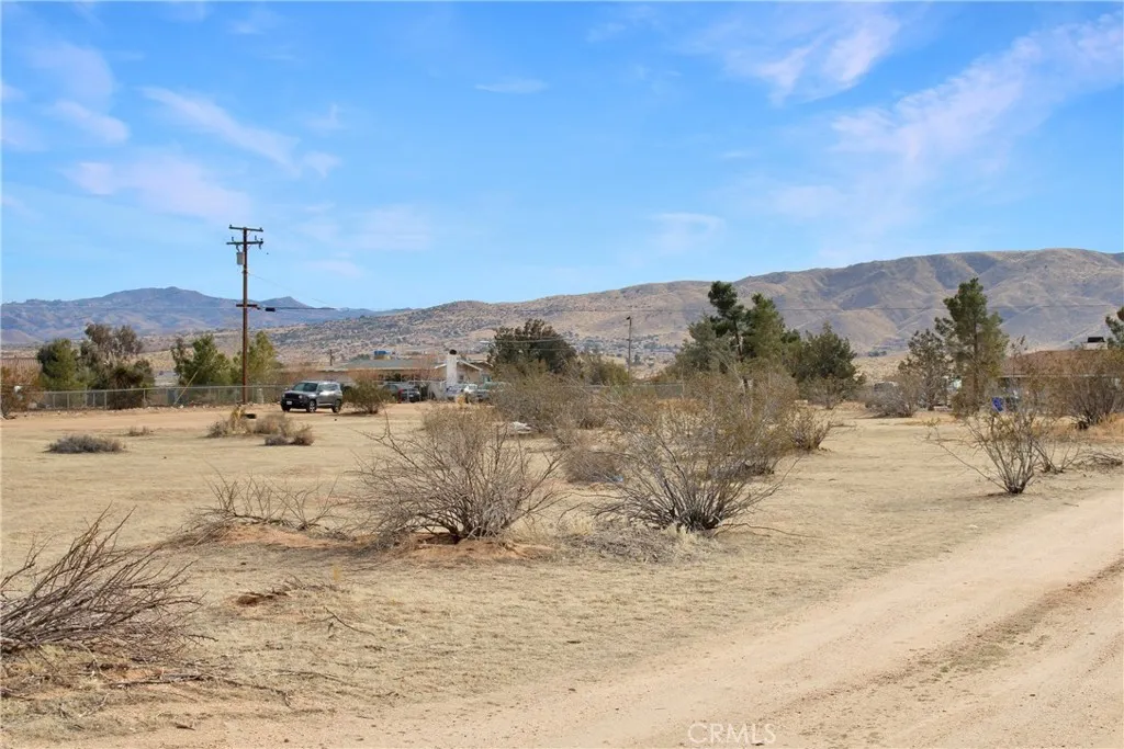22648 Joshua Road Apple Valley, CA 92308 - Photo 1 of 1 a view of a road with mountains in the background