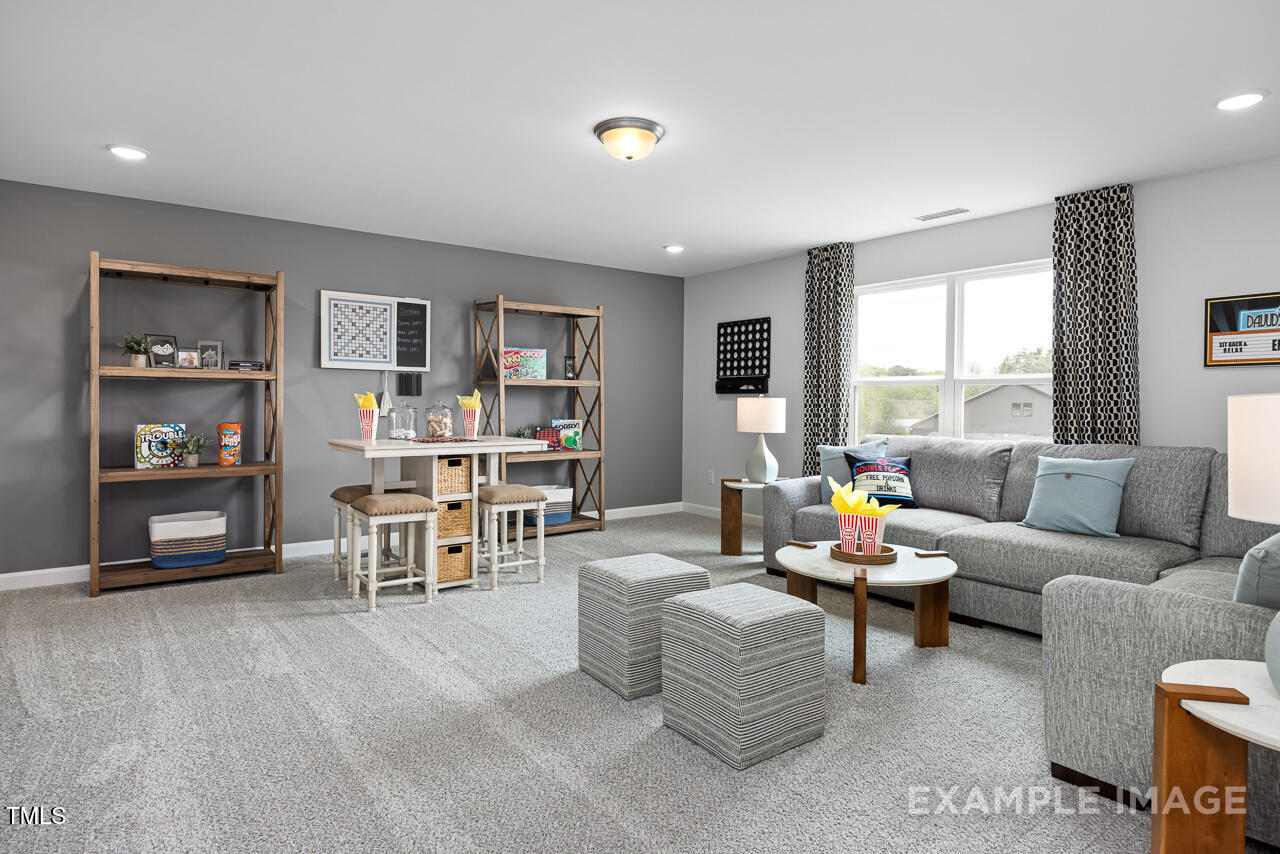 297 Crop Road Angier, NC 27501 - Photo 20 of 23 a living room with furniture and a flat screen tv