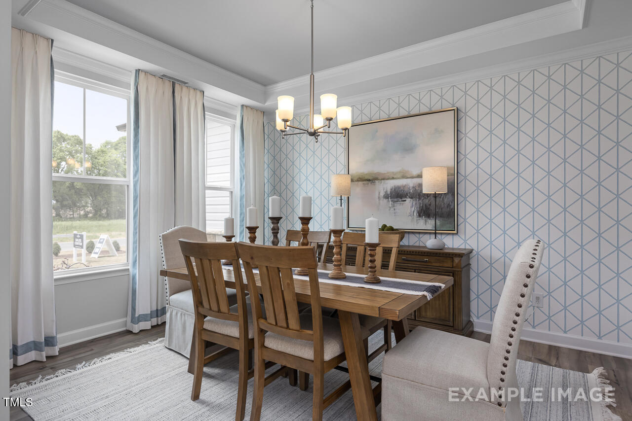 297 Crop Road Angier, NC 27501 - Photo 3 of 23 a view of a dining room with furniture window and wooden floor