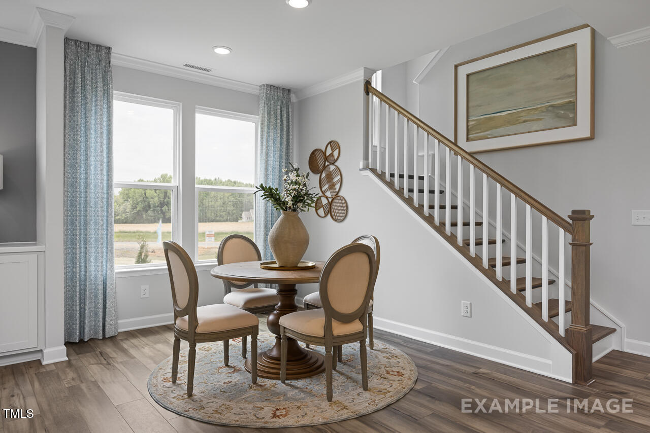 297 Crop Road Angier, NC 27501 - Photo 7 of 23 a view of a dining room with furniture window and wooden floor