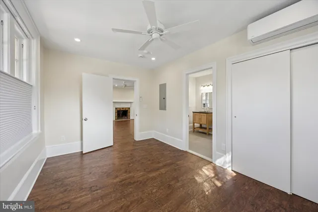 an empty room with windows and cabinet
