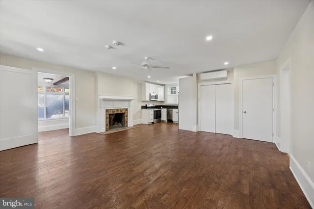 a view of a big room with wooden floor fire place and fire place