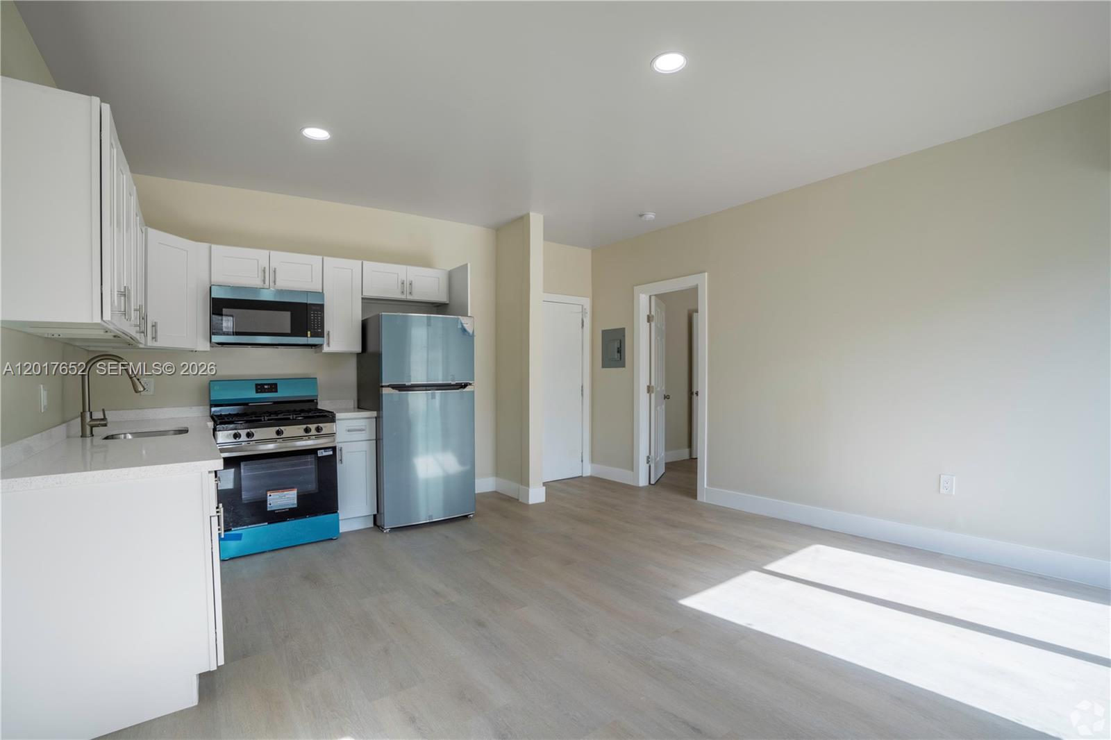 433 Southwest 6th Street, Unit 15 Miami, FL 33130 - Photo 4 of 12 a kitchen with stainless steel appliances granite countertop a refrigerator oven a sink and dishwasher