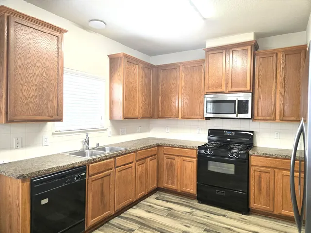a kitchen with a sink stove and microwave