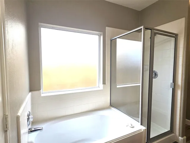 a bathroom with a bathtub and a shower