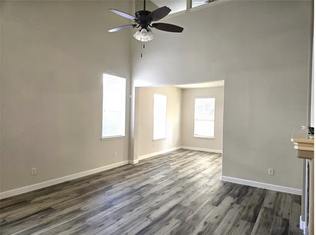 wooden floor in an empty room with a window