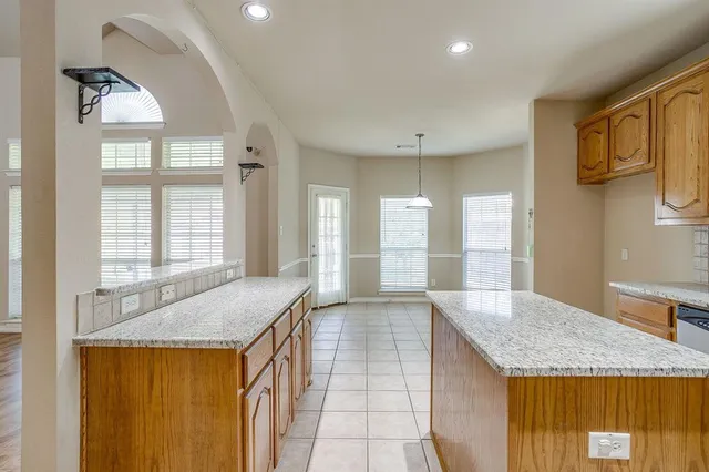 a kitchen with stainless steel appliances granite countertop a sink and a granite counter tops