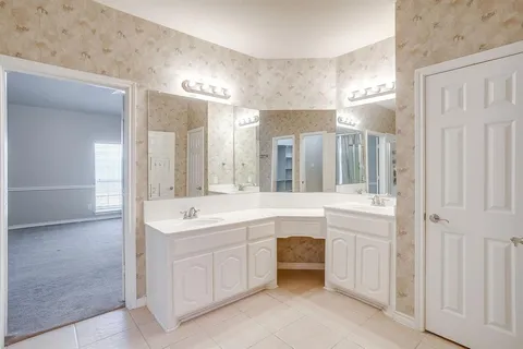 a bathroom with a sink double vanity and a mirror