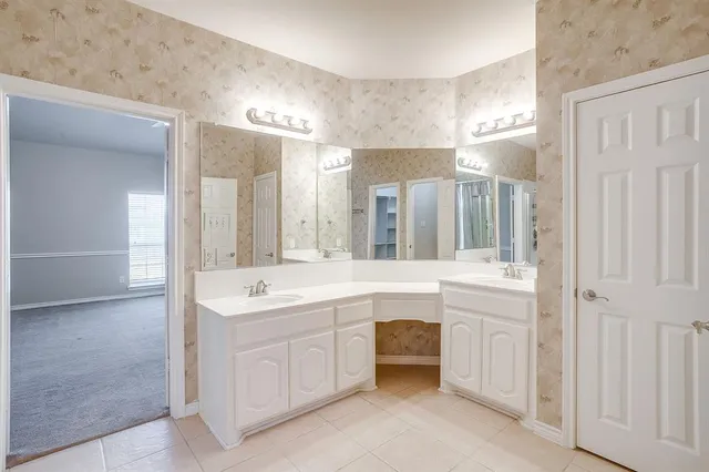 a bathroom with a sink double vanity and a mirror