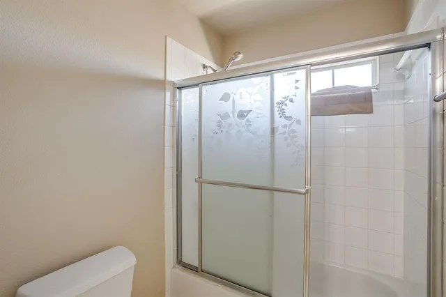 a bathroom with a shower and toilet