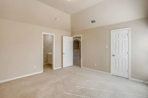 an empty room with a window and closet