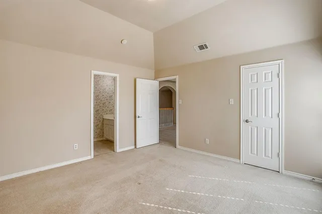 an empty room with a window and closet