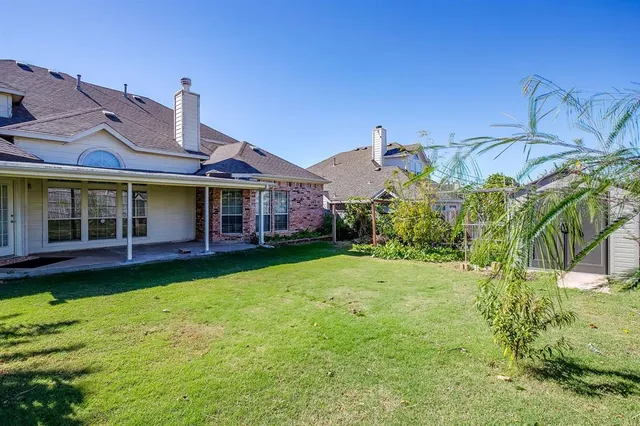a view of a house with swimming pool and a yard