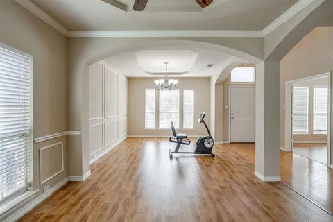 a view of a room with wooden floor and windows