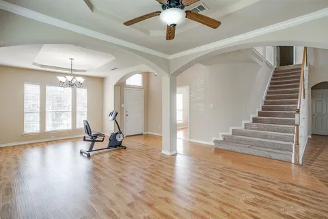 a view of a room with wooden floor and windows