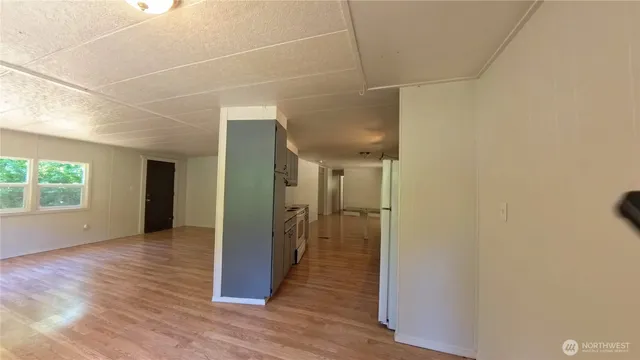 a view of hallway with wooden floor